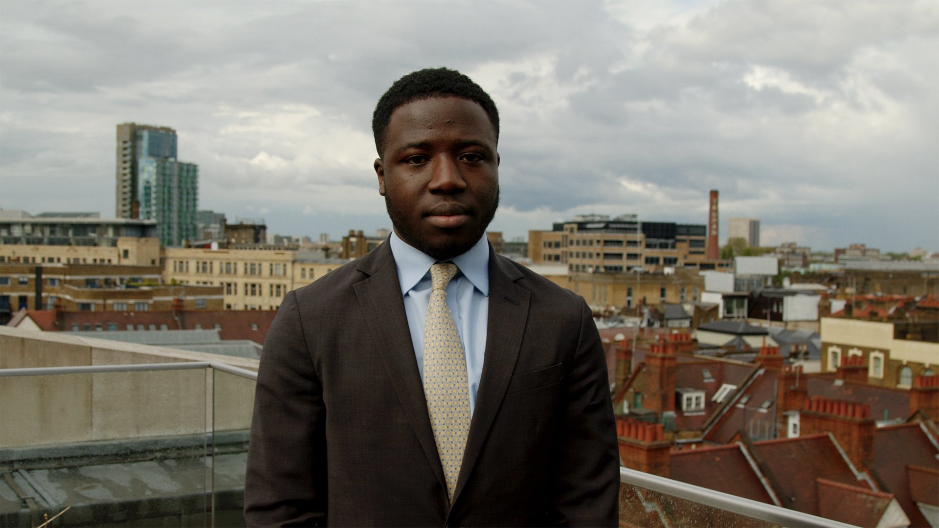 Man in front of city skyline, image from campaign film.